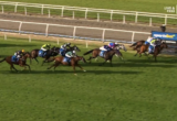 Horses race down a turf track with jockeys in bright silks, approaching the finish line under a blue banner.