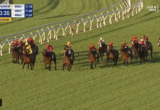 Horses and jockeys race down a grassy track with a white railing, scoreboard shows 0:50.35 and 360m to go at top left.