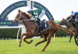 Horse and jockey in green-and-white silks sprint toward the finish at Warwick Farm racecourse, with a blue-green arch behind them.