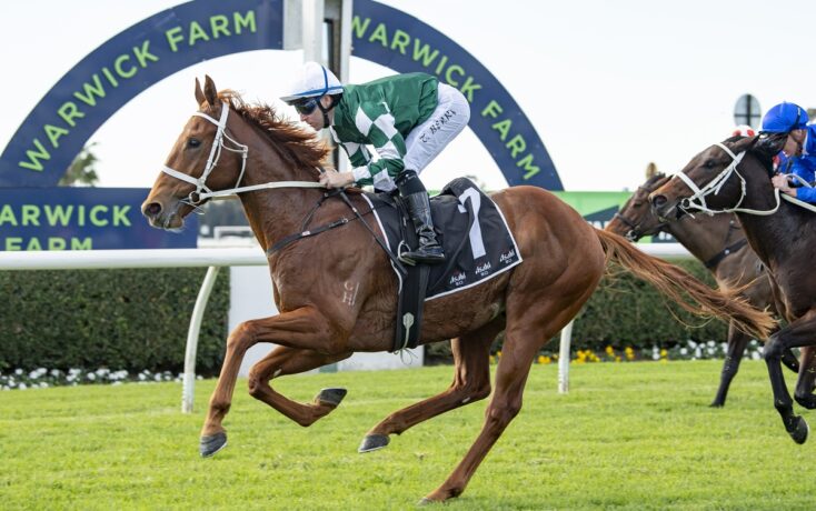 Horse and jockey in green-and-white silks sprint toward the finish at Warwick Farm racecourse, with a blue-green arch behind them.