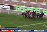 Horse race in progress at Flemington, several jockeys and horses close together on the track with a green infield.