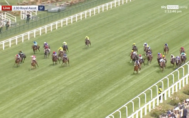 Horse race on a green turf track at Royal Ascot, several riders in colorful silks chasing the lead.