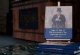 Book cover on a stand: 'Sale O Sale O: The Auctioneer's Tale' by William Inglis & Son Ltd.